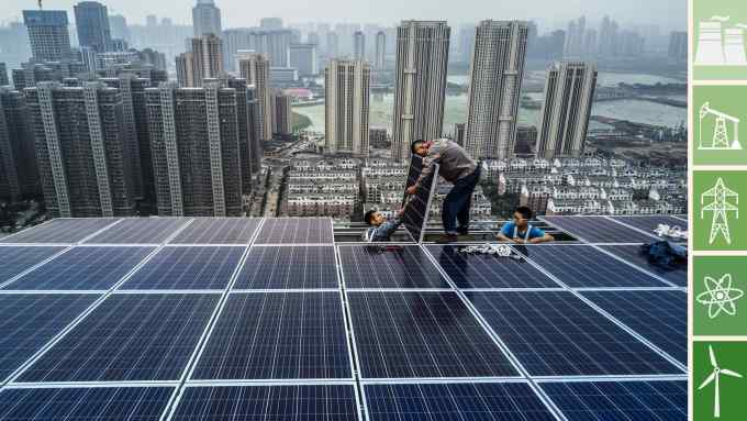 WUHAN, CHINA - MAY 15: Chinese workers from Wuhan Guangsheng Photovoltaic Company work on a solar panel project on the roof of a 47 story building in a new development on May 15, 2017 in Wuhan, China. China consumes more electricity than any other nation, but it is also the world's biggest producer of solar energy. Capacity in China hit 77 gigawatts in 2016 which helped a 50% jump in solar power growth worldwide. China is now home to two-thirds of the world's solar production, though capacity and consumption remain low relative to its population. Still, the country now buys half of the world's new solar panels Ñ which convert sunlight into energy, and are being installed on rooftops in cities and across sprawling fields in rural areas. Greenpeace estimates that by 2030, renewable energy could replace fossil fuels as China's primary source of power, a significant change in a country considered the world's biggest polluter. China's government has officially committed to development of renewable energies to ease the countryÕs dependence on coal and other fossil fuels, though its strategic investments in the solar panel have created intense global competition. (Photo by Kevin Frayer/Getty Images)