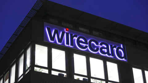 An logo sits above illuminated office windows at the Wirecard AG headquarters at dawn in the Aschheim district of Munich, Germany, on Tuesday, Feb. 12, 2019. Wirecard broke federal securities law by failing to act on an executive’s misconduct and misleading investors about it, a complaint filed Feb. 8 in the Central District of California alleges. Photographer: Michaela Handrek-Rehle/Bloomberg