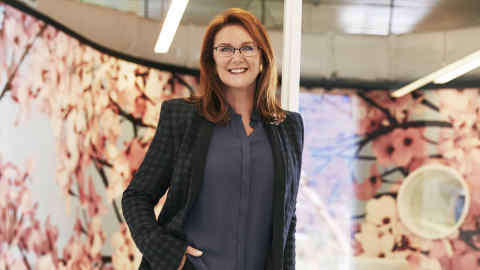 Portrait of Naomi Milgrom at the Sussan HQ, Cremorne, Melbourne Credit: Steven Chee In the background: Franz West 'Pouf' 2012 Steel, foam, linen and cardboard 80cm x 220 cm x 150 cm (hxwxd) Thomas Demand Wallpaper specifically designed for space