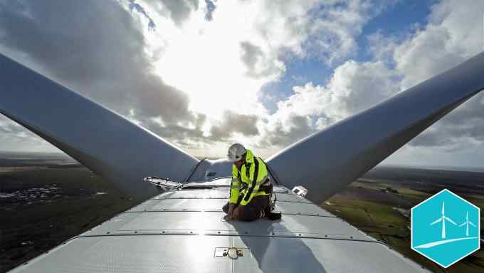 An employee checks a cable on the nacelle of a Vestas A/S V136 wind turbine during operational testing at the Danish National Test Center for Large Wind Turbines in Osterild, Denmark, on Monday, April 18, 2016. "The doubling of turbine size this decade will allow wind farms in 2020 to use half the number of turbines compared to 2010," said Tom Harries, an industry analyst at Bloomberg New Energy Finance. Photographer: Chris Ratcliffe/Bloomberg