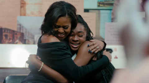 Michelle Obama embraces a fan in a scene from ‘Becoming’ © Netflix