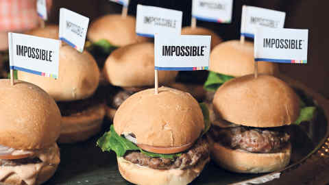 The Impossible Burger 2.0, the new and improved version of the company's plant-based vegan burger that tastes like real beef is introduced at a press event during CES 2019 in Las Vegas, Nevada on January 7, 2019. - The updated version can be cooked on a grill and has a better flavor and lowered cholesterol, fat and calories than the original. "Unlike the cow, we get better at making meat every single day," CEO of Impossible Foods CEO Pat Brown. (Photo by Robyn Beck / AFP) (Photo credit should read ROBYN BECK/AFP/Getty Images)