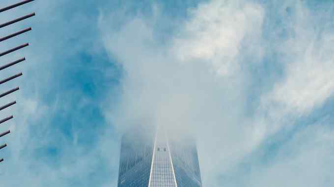 high-rise building obscured by a cloud