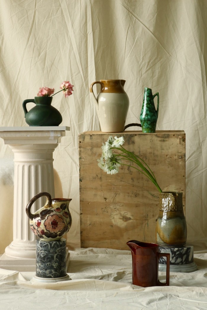 Clockwise from top left: short ceramic vase, £20. Glazed water jug, £60. Speckled ceramic vase, £50. Pottery jug, £65. Modernist red jug, £40. Floral ceramic jug, £50