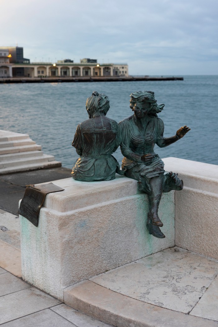 The “Le Ragazze di Trieste” statue on the waterfront in front of Piazza Unità d’Italia