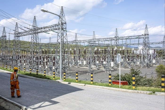 A worker passes an electricity substation at the Olkaria Geothermal Complex