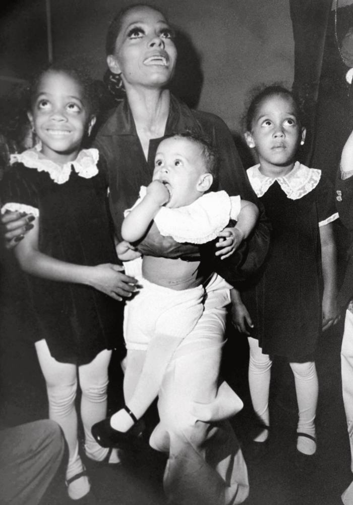 As a baby with her mother and sisters Rhonda (left) and Chudney (right) in 1976