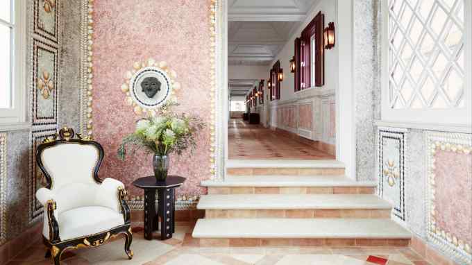 A first-floor corridor with limewash trompe l’oeil details at Vermelho