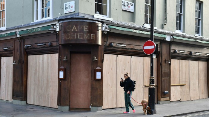 A café in Soho, London, is boarded up the day after pubs and restaurants across the UK were ordered to close last month to stop the spread of coronavirus