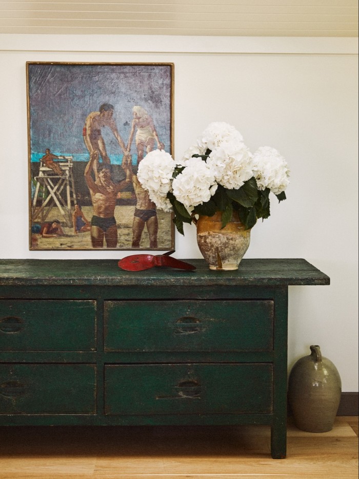 Brown and Konig’s sitting room, with a green chest by Original House, untitled painting from Lacy Gallery and hydrangeas by Flowerbx