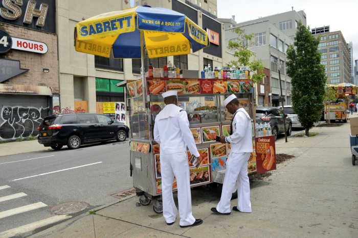 US Navy service members order food at a street vendor