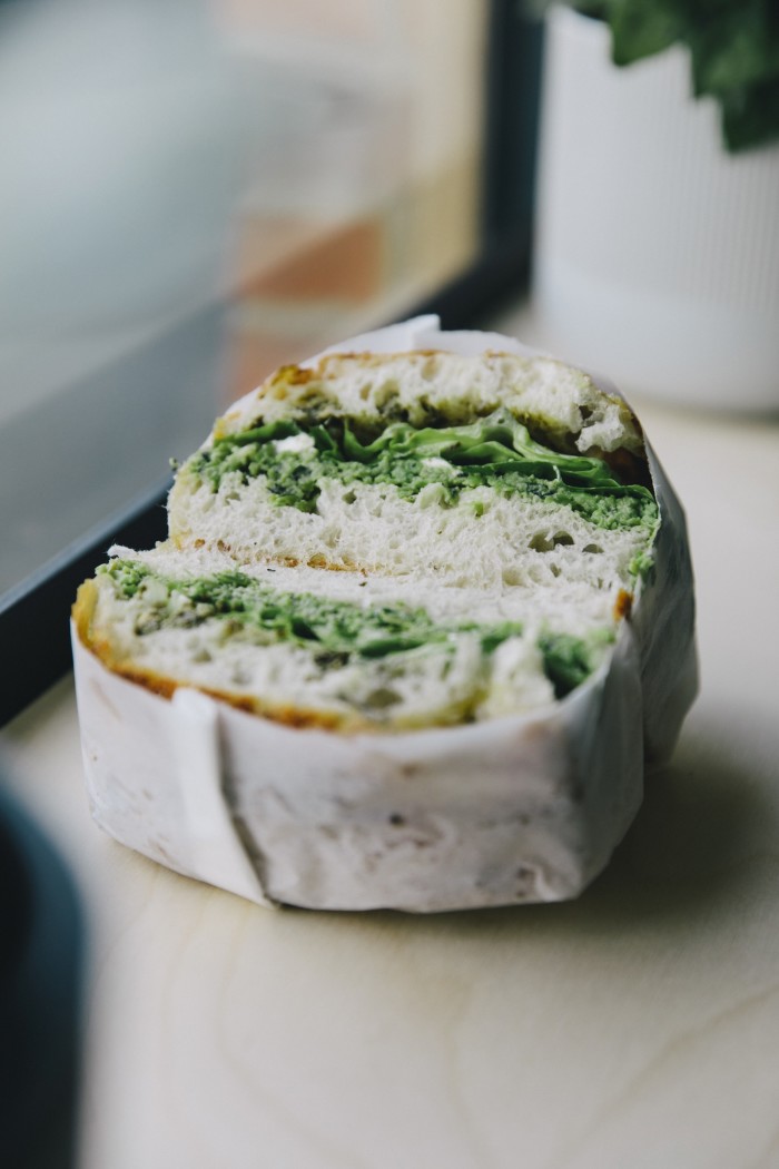 A mint, pea and broad bean smash sandwich with feta and cos lettuce on focaccia 