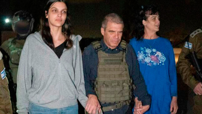 Judith Raanan, right, and her daughter Natalie are escorted by Israeli soldiers and Gal Hirsch, Israel’s special coordinator for the return of hostages, centre