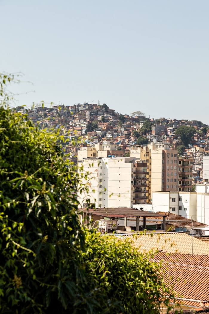  Photograph of a hilly urban landscape with terracotta pitched roofs and blocks of flats
