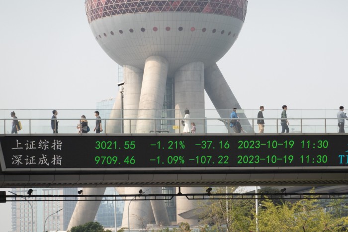 The midday closing stock index is displayed on the big screen of the Lujiazui Skybridge in Pudong New Area in Shanghai, China