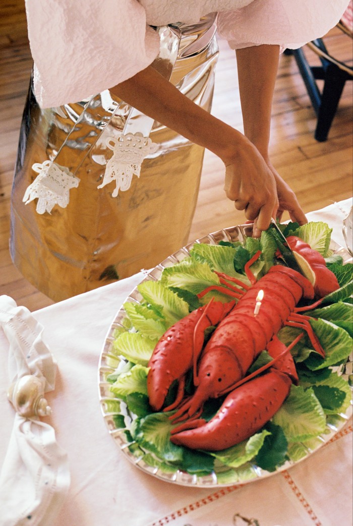 Cutting the lobster-shaped orange blossom cake