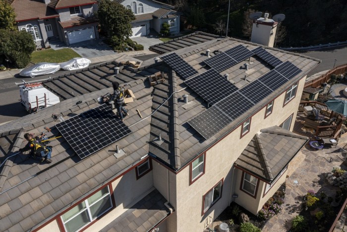 Save A Lot Solar contractors install LG Electronics solar panels on a home in Hayward, California