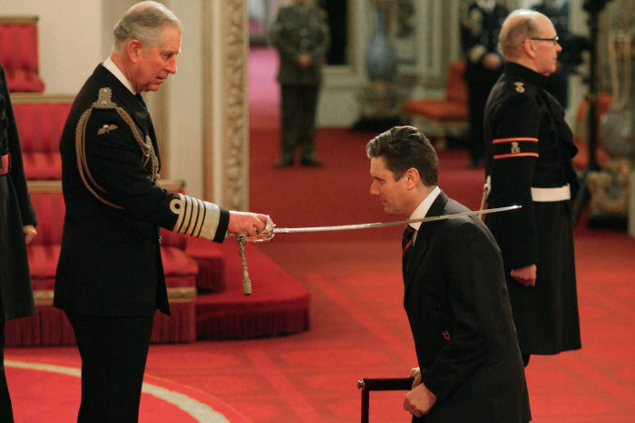 Starmer being knighted by the then Prince of Wales in 2014