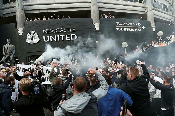 Newcastle United supporters celebrate outside the club’s stadium St James’ Park