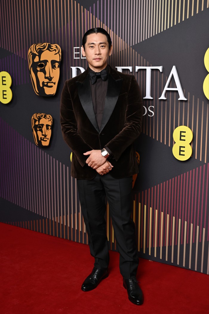 Teo Yoo wears a Zegna tuxedo on the Baftas red carpet