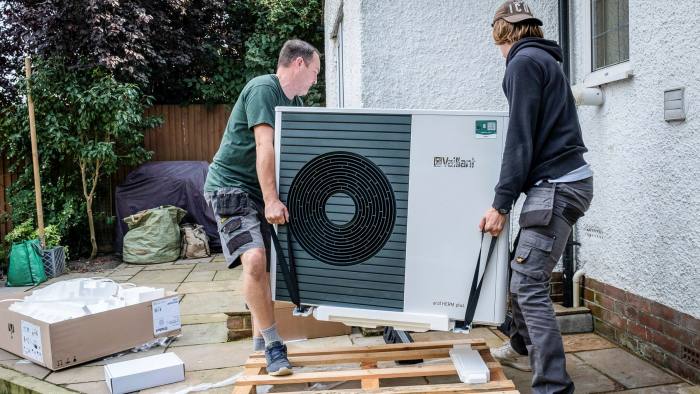 Pump up the volume: workers installing an air-source heat pump in Kent, England