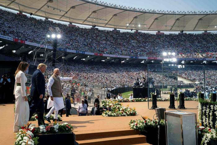At Motera Stadium in Ahmedabad, Donald and Melania Trump are escorted onstage by Narendra Modi in February 2020 — a year before the stadium was renamed after the Indian prime minister