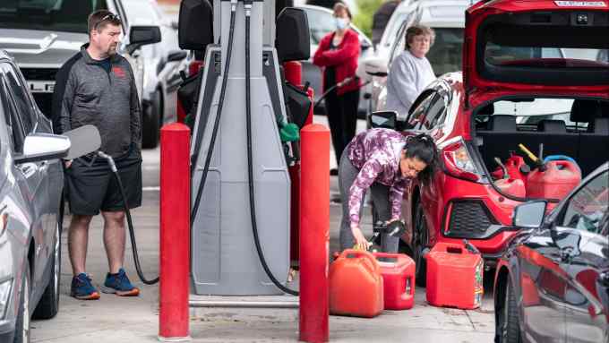 motorists refuelling at a gas station