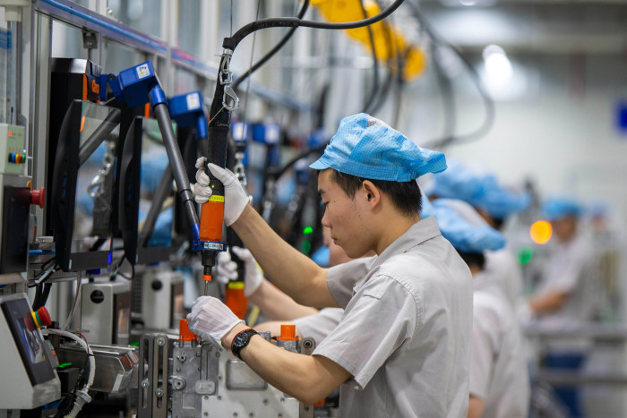 Chinese workers assemble batteries for electric vehicles at the plant of Delta Electronics