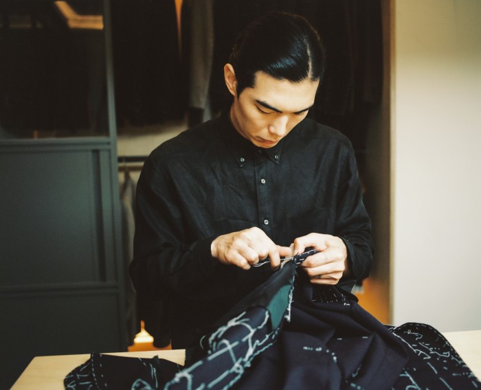 Master tailor Lee Min Yeob at work on a coat
