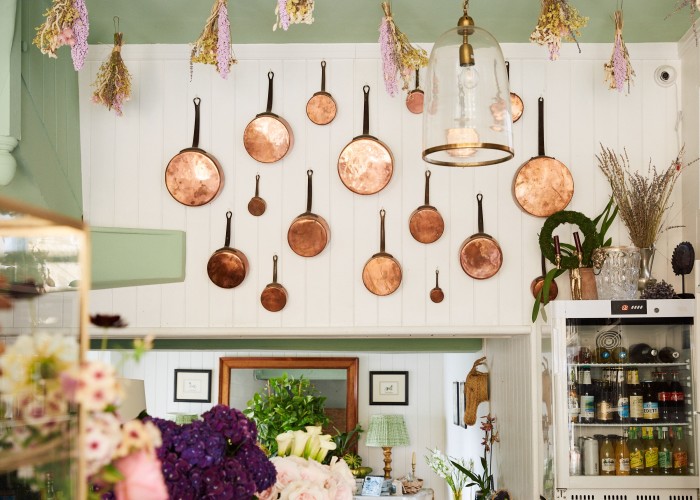 Copper pans displayed on the walls inside the deli