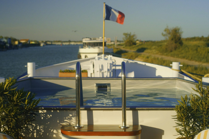 The prow of the barge flying a smallFrench national flag