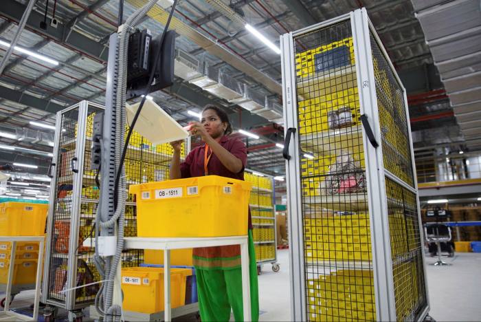A worker at an Amazon facility. The e-commerce platform is coming under intense scrutiny from regulators