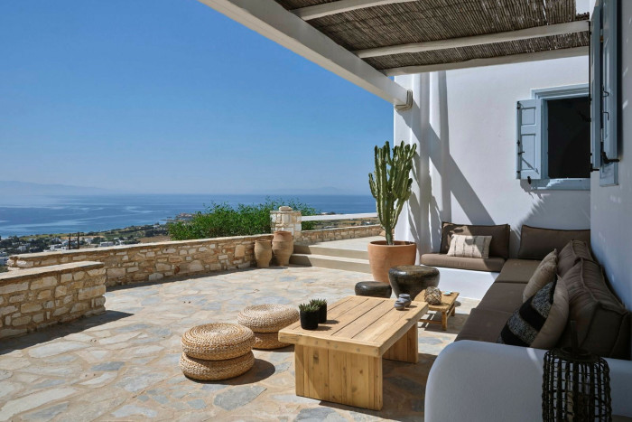 The view of a town and sea from the sundrenched terrace of a whitewashed villa 