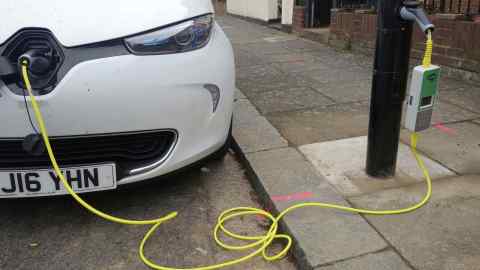 An electric car is charged using a Ubitricity charger installed in a lamppost