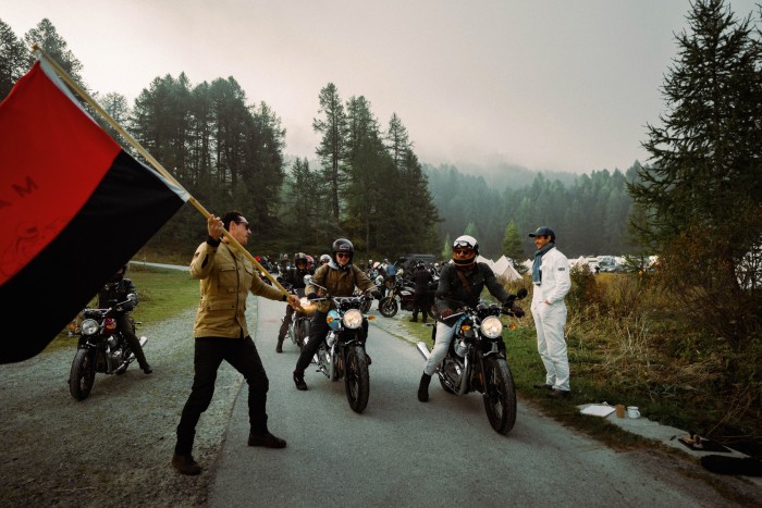 Malle co-founder Robert Nightingale flags riders away from the Maloja camp beside Lake Fils
