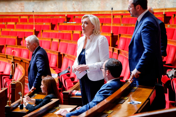Marine Le Pen, centre, attends a parliament session before the National Assembly rejected a motion of censure tabled by LFI, which intended to denounce the country’s budgetary situation