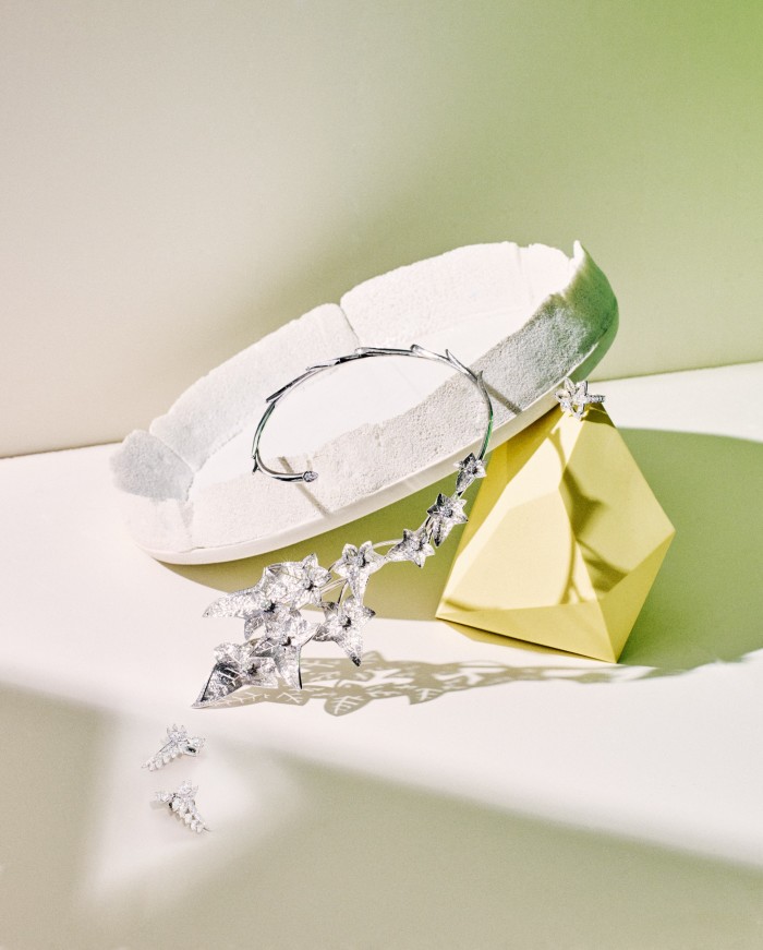 From left: Chaumet white‑gold and diamond Joséphine Valse Impériale earrings. Boucheron white-gold and diamond Lierre de Paris necklace. De Beers white-gold and diamond Blooming Lotus ring