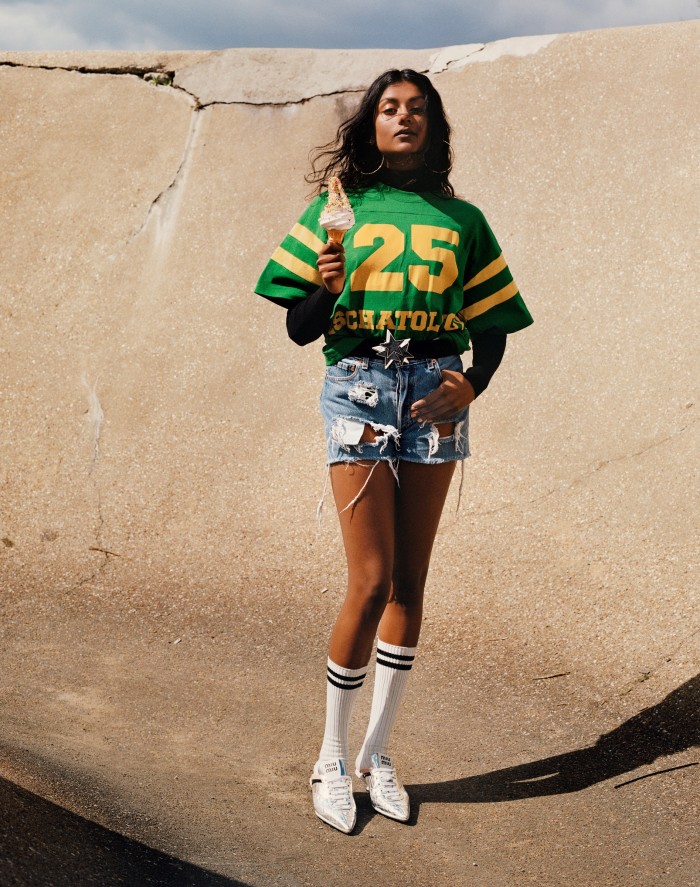 Gucci cotton jersey crewneck, £400, and fine-wool turtleneck, £660. Miu Miu technical fabric sneakers, £750. Vintage gold hoop earrings, POA, from Contemporary Wardrobe. Vintage 1980s elasticated nylon and resin belt, POA, from Carlo Manzi. Vintage denim shorts and cotton sport socks, both POA, from Costume Studio