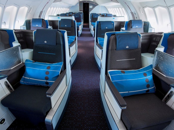 Blue cushions sit on large airline seats