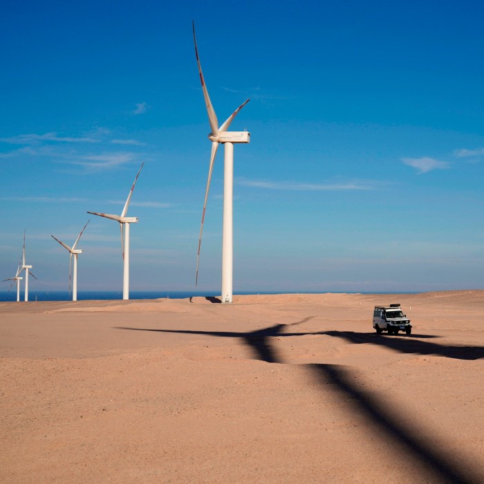 A vehicle drives near wind turbines at Lekela wind power station, near the Red Sea city of Ras Ghareb