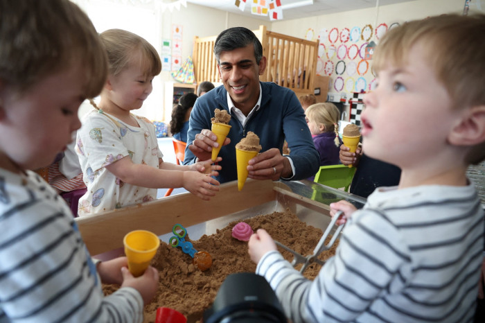 Rishi Sunak plays with children during a visit to Imagination Childcare 