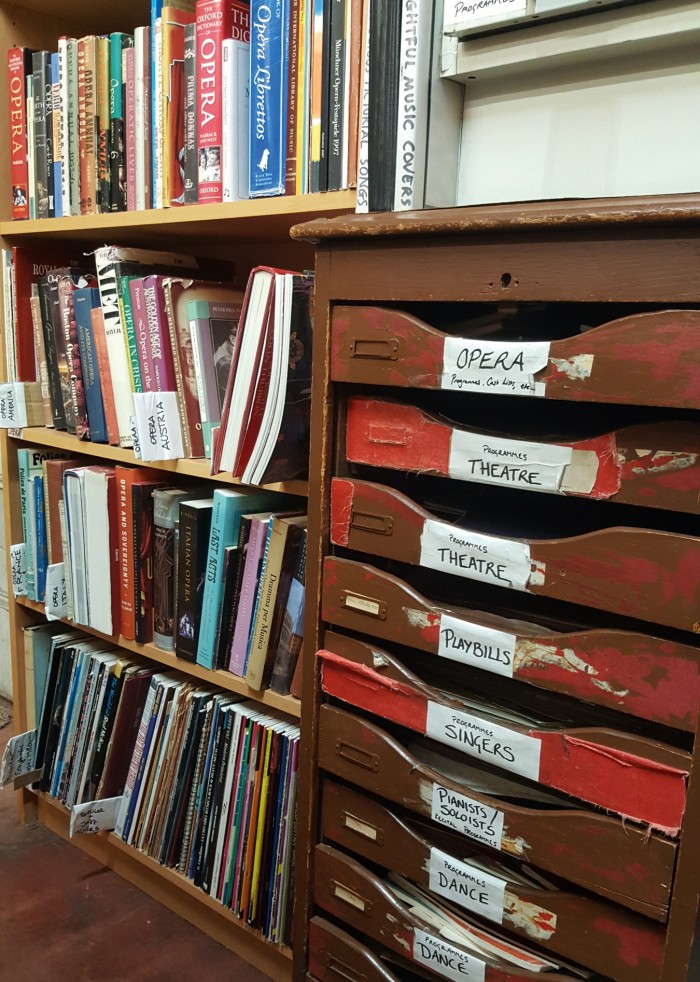Posters and musical programmes filed in an antique cabinet