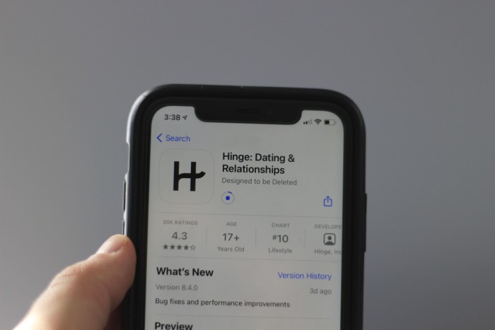 A mobile phone displays the Hinge app