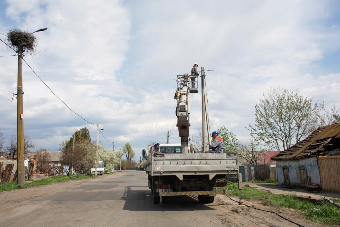 Communal workers carry out electrical repairs in Borodyanka
