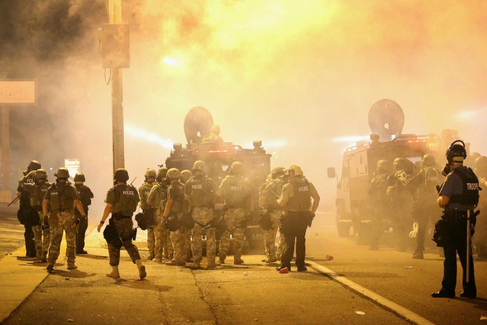 Police advance through tear gas during a protest at the killing of Michael Brown in Ferguson, Missouri, in 2014. The teenager's death at the hands of a white police officer sparked a summer of unrest
