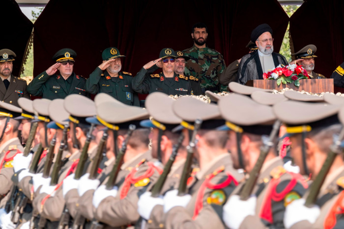 Ebrahim Raisi watches a military parade in Tehran