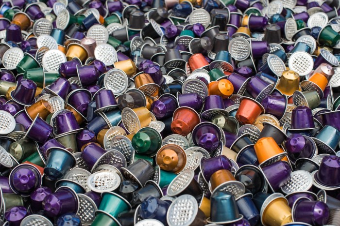 Lots of used Nespresso pods jumbled together