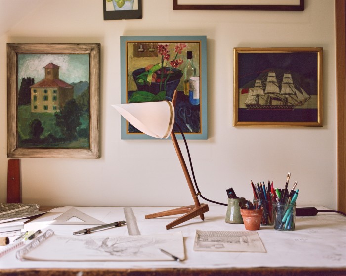 Armitage Desk Lamp, by Joe Armitage, on Marthe’s desk, surrounded by her painting collection