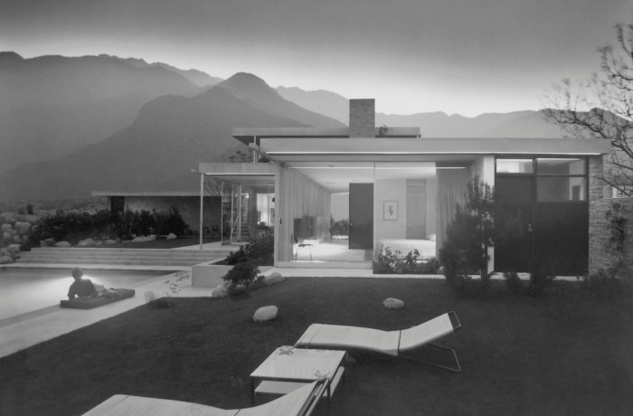 black and white photo of home with pool, lawns and deckchairs
