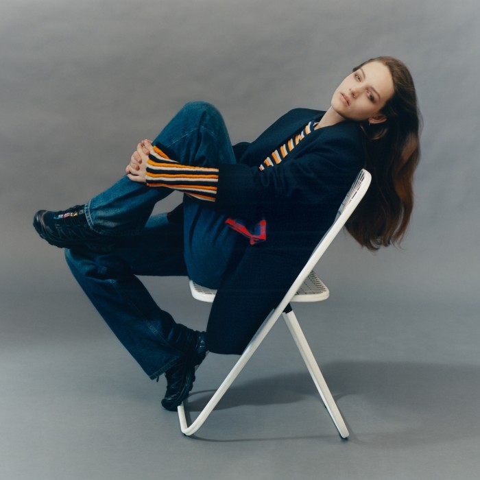 Jil Sander by Lucie and Luke Meier wool jacket, £2,190. Re-See vintage Balenciaga knit top, €680. Balenciaga denim and cotton poplin hybrid shirt trousers, £1,150. Salomon S/LAB XT-6 trainers, £155. Alex Eagle x Otiumberg gold vermeil medium single earring, £69. Chair, throughout, from a selection at roomsofclapton.com